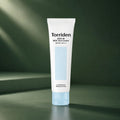 Crème Solaire Douce Dive-In SPF50+ PA++++ - visuel produit sur fond vert premium