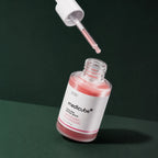 Medicube Ampoule PDRN Rose et Peptides avec pipette sur fond vert profond