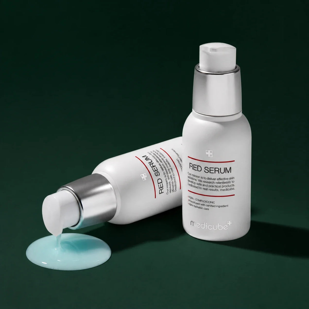 Medicube Sérum Apaisant Red, deux flacons et texture bleue sur fond vert profond