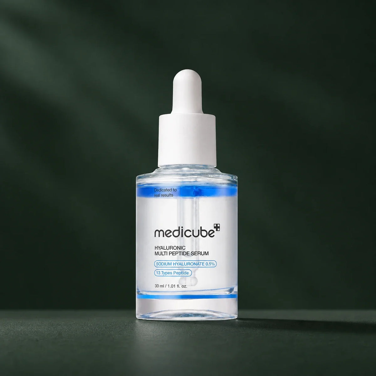 Sérum Medicube hyaluronique multi-peptides sur fond vert profond