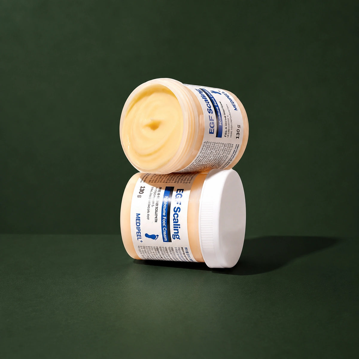 Crème Exfoliante Hydratante pour les Pieds à l’EGF MEDIPEEL – vue 3 sur fond vert profond.
