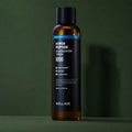 Lotion Tonique Booster aux Peptides WELLAGE sur fond vert profond